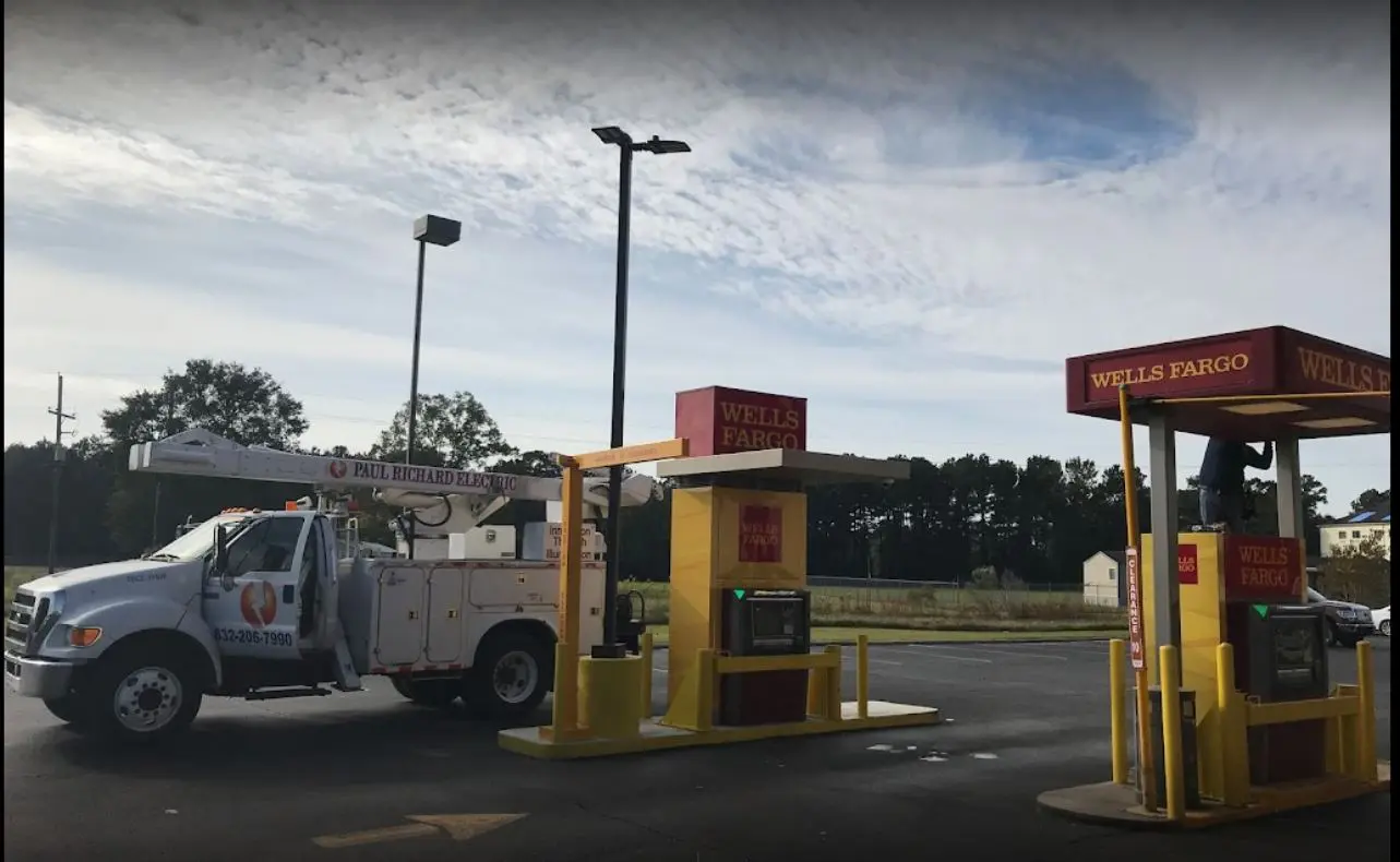 A truck parked in front of a gas station.