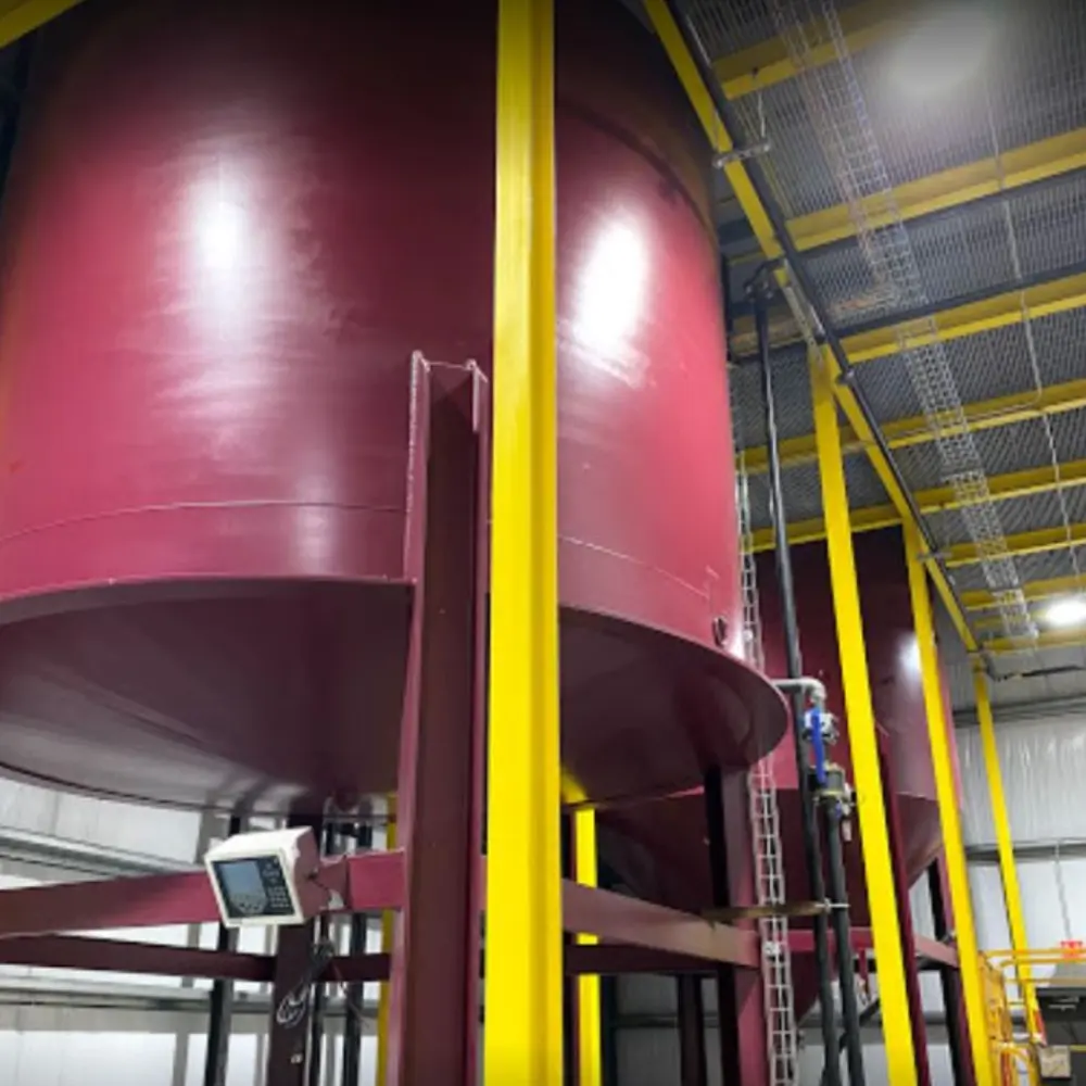 A large red tank in a warehouse.