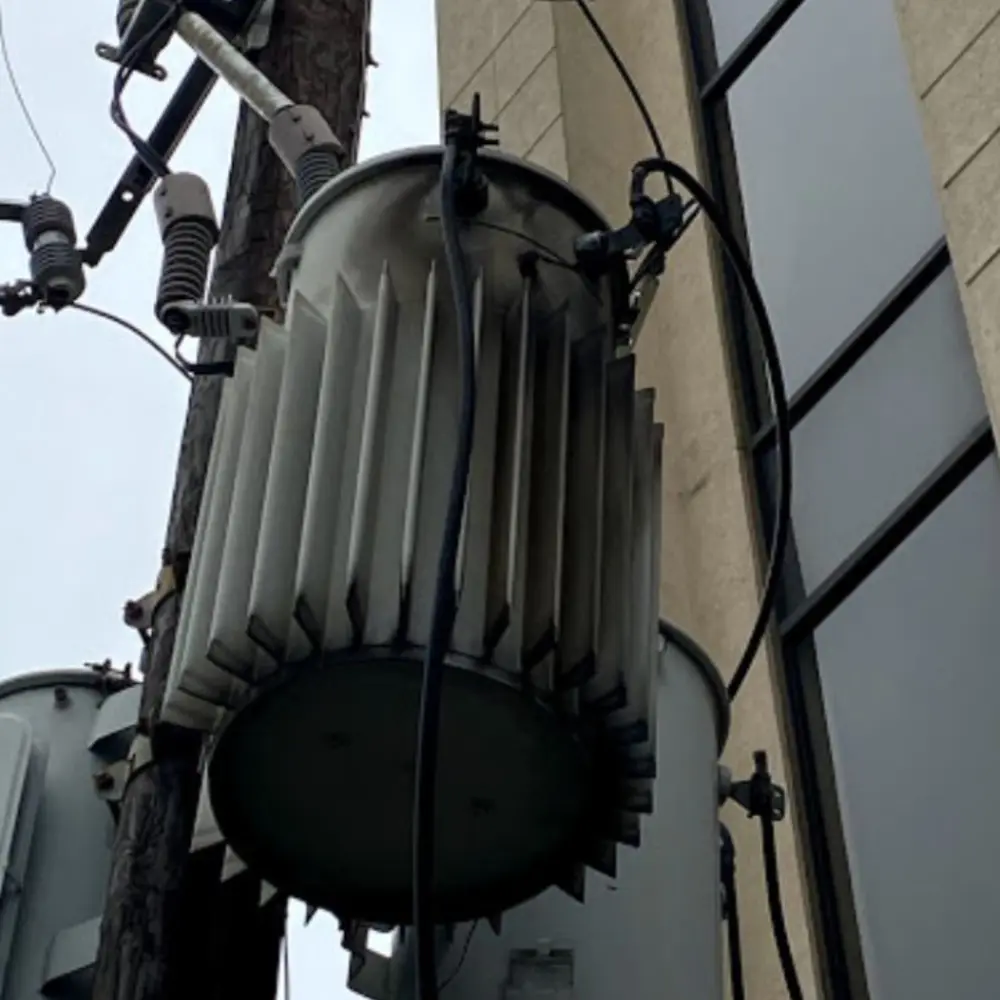 A large metal object hanging from the side of a building.