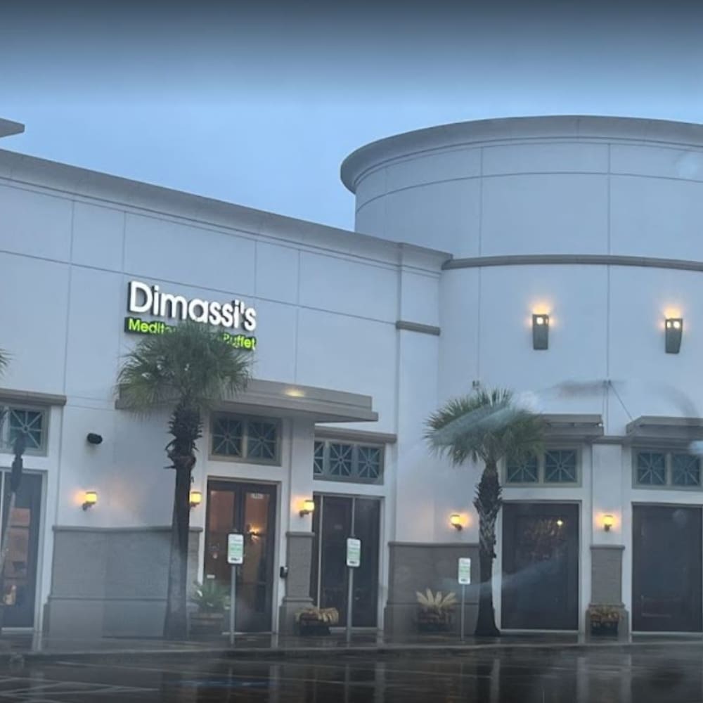 A large building with palm trees outside it