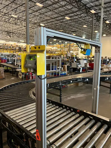 A conveyor belt in an industrial setting with many items.