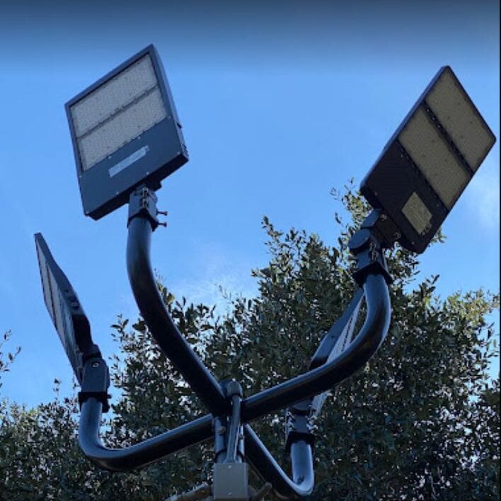 A street light with three solar panels on it.